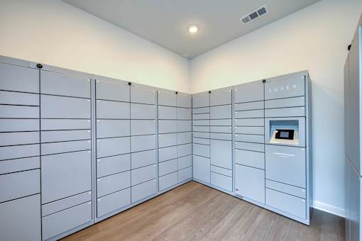 A room with a wall of lockers and a sign that says "LUXER".