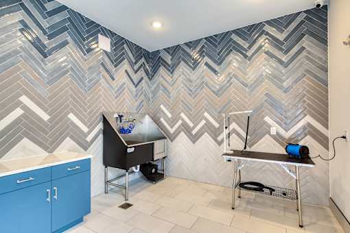 A bathroom with a blue and white chevron pattern on the wall.