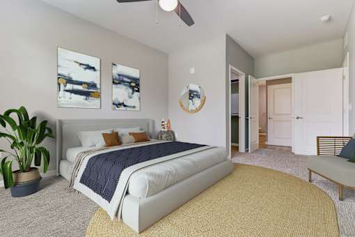 A bedroom with a large bed and a ceiling fan.