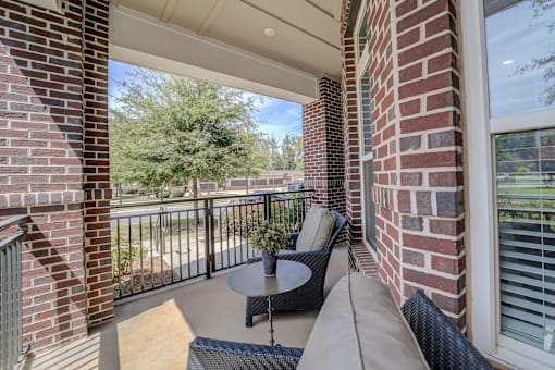 A balcony with a table and chairs is shown.