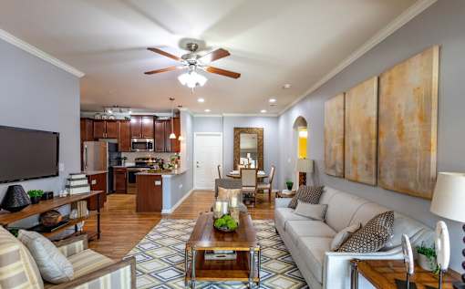 a living room with a couch and a ceiling fan