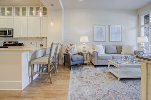 A living room with a grey couch and a white coffee table.