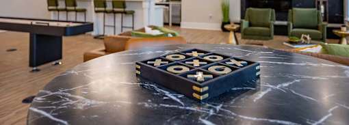 A game of checkers is set up on a table.