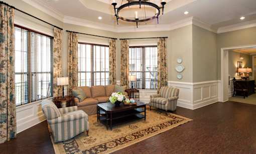 A living room with a striped chair and a coffee table.