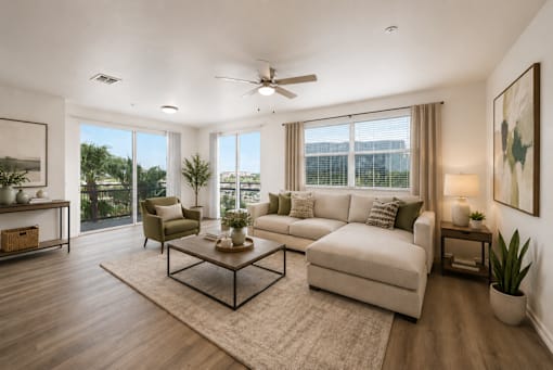 A living room with a white couch, a coffee table, and a ceiling fan.