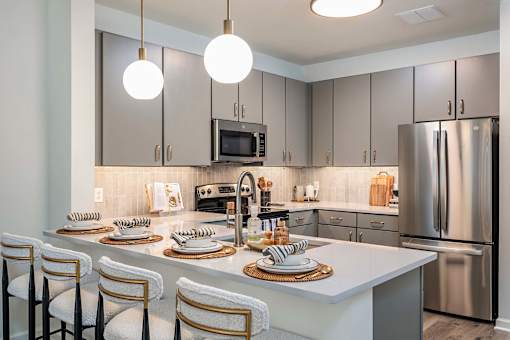 A modern kitchen with a center island and stainless steel appliances.