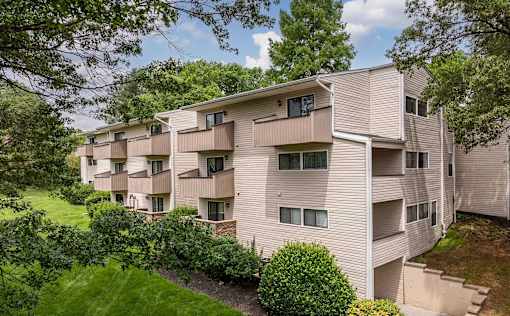 A large apartment complex with a green lawn in front.