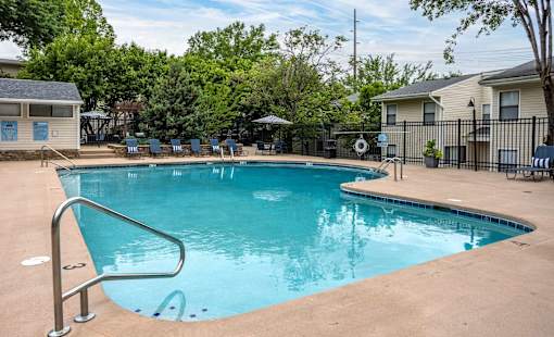 A small pool with a ladder in the middle of it.