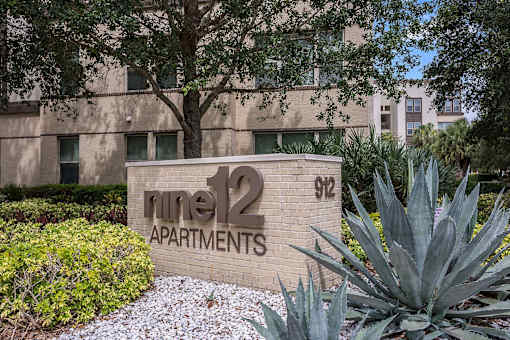 A sign for "line 12 Apartments" is displayed in front of a building.