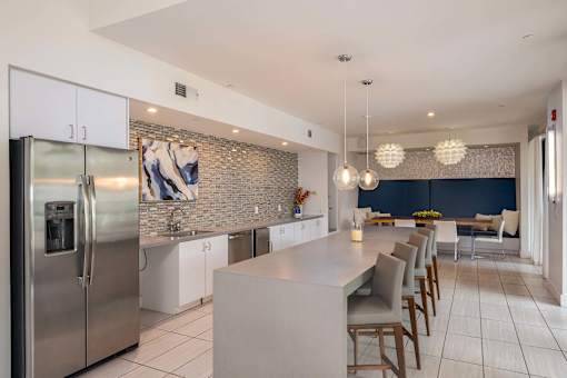 A modern kitchen with a large island and stainless steel appliances.