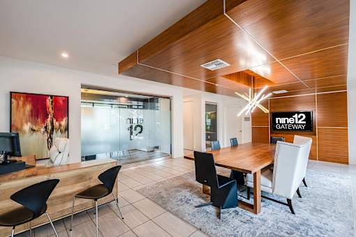 A conference room with a long table and chairs.