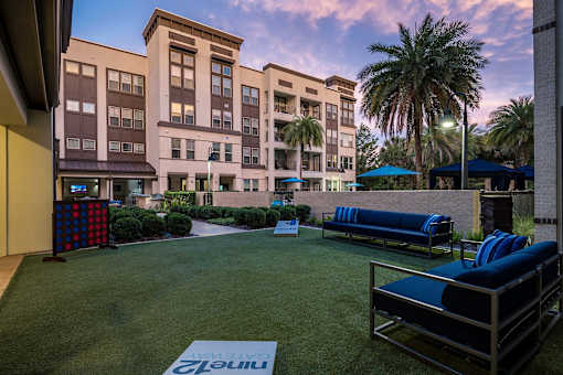 A grassy area with a sign that says "Clean" in front of a building.