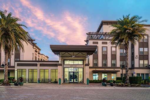 A building with a palm tree in front of it.