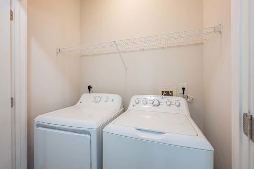 A small laundry room with a washer and dryer.
