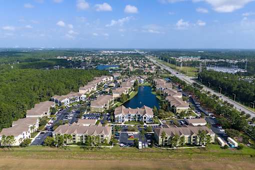A bird's eye view of a residential area with houses and a lake.