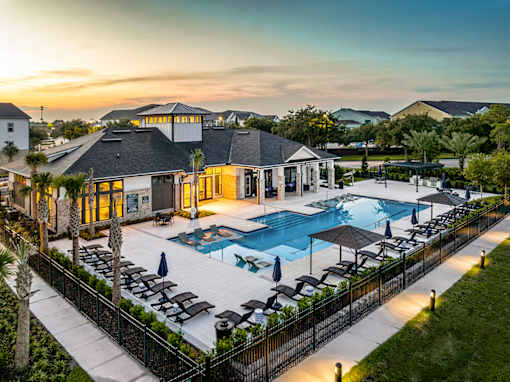 A luxurious resort with a swimming pool and lounging area.