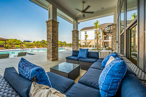 A patio with a sofa and pillows is shown.