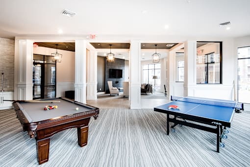 A room with a pool table and a ping pong table.