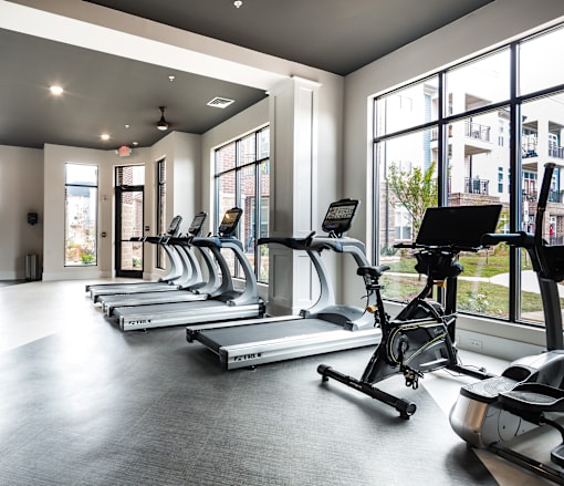 A gym with treadmills and exercise bikes.