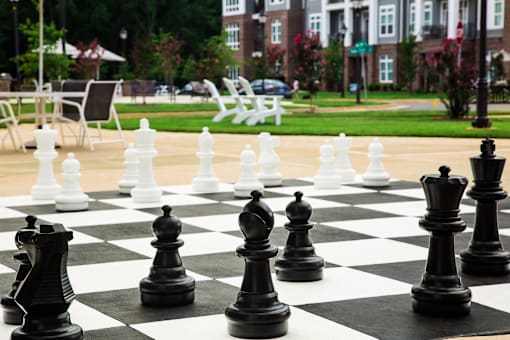A giant chess board in the middle of a park.