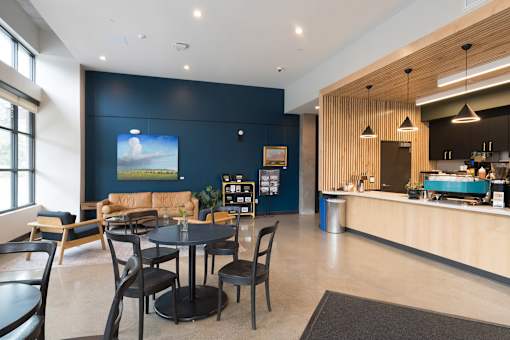 A modern dining area with a large screen on the wall.
