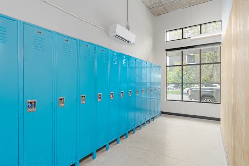 A row of blue lockers in a room.