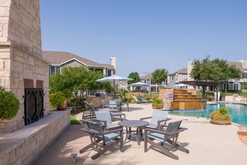 a patio with tables and chairs next to a swimming pool at Orion Prosper Lakes, Prosper, TX, 75078