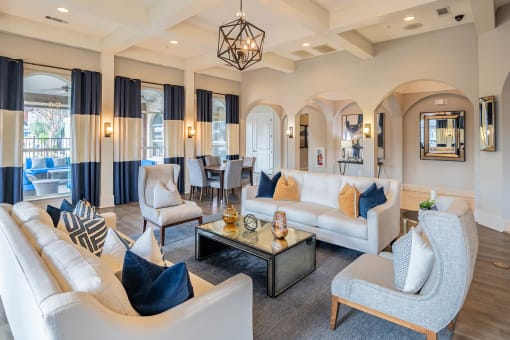a living room with couches and chairs and a table  at Orion Prosper Lakes, Texas, 75078