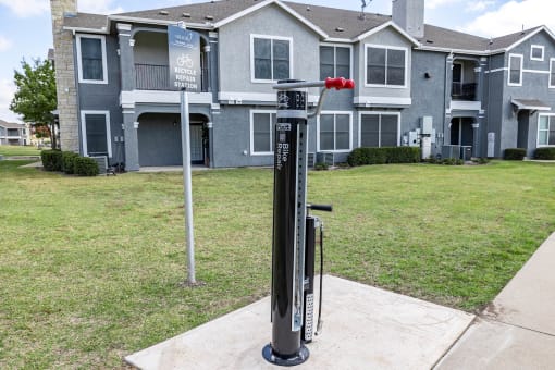 a parking meter in front of an apartment building  at Orion Prosper Lakes, Prosper, Texas