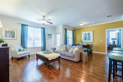 a living room with a couch and a chair  at Orion Prosper, Texas, 75078