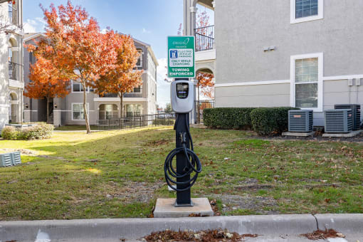a parking meter in front of an apartment building  at Orion Prosper, Texas, 75078