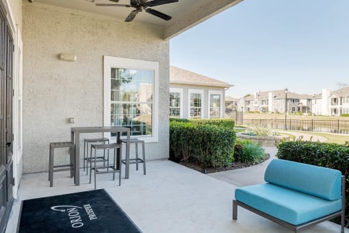 a patio with a table and chairs in front of a house at Orion Prosper, Prosper, TX, 75078