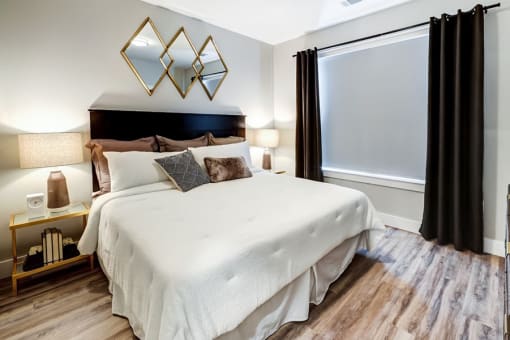 Bedroom with lamps at Icon Apartment Homes at Ferguson Farm, Montana
