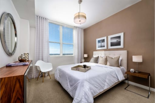 a bedroom with a bed and a desk with a chair at Regatta at New River, Fort Lauderdale, 33301