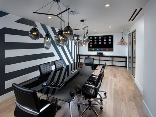 a conference room with black chairs and a black table and black and white stripes on the wall at Saba Pompano Beach, Pompano Beach, 33062