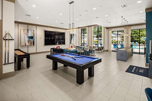 A billiard table is in the middle of a room with a pool table and a bar.