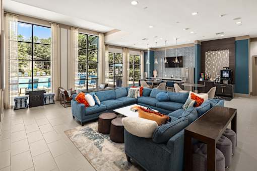 A modern living room with a large blue sectional sofa and a television.