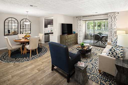 A living room with a dining table and chairs.