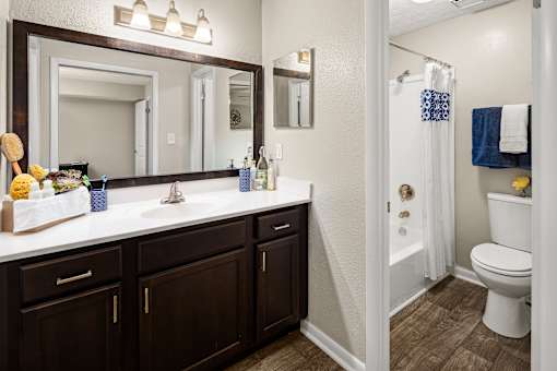 A bathroom with a white toilet and a white sink.