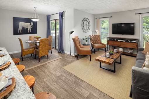 A living room with a grey couch and a wooden coffee table.