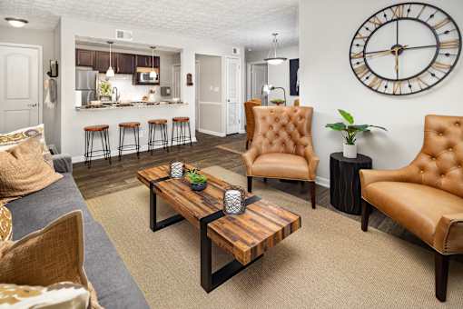 A living room with a brown leather chair and a wooden coffee table.