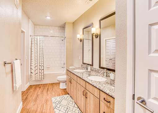 A bathroom with a toilet, sink, and shower.