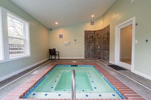 A small indoor swimming pool with a tiled edge.