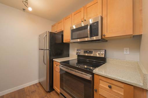 A kitchen with wooden cabinets and stainless steel appliances.