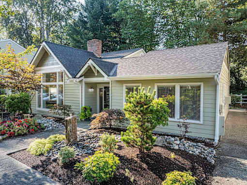 A house with a front yard and a small garden.