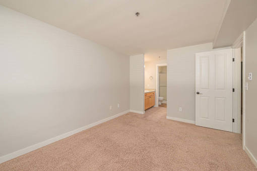 A room with a carpeted floor and white walls.