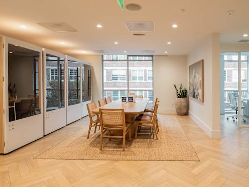 A dining room with a table and chairs.