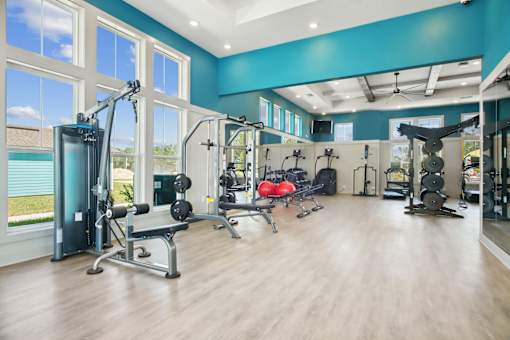 A spacious home gym with a variety of exercise equipment.