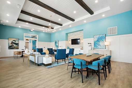 A modern dining room with a wooden table and blue chairs.