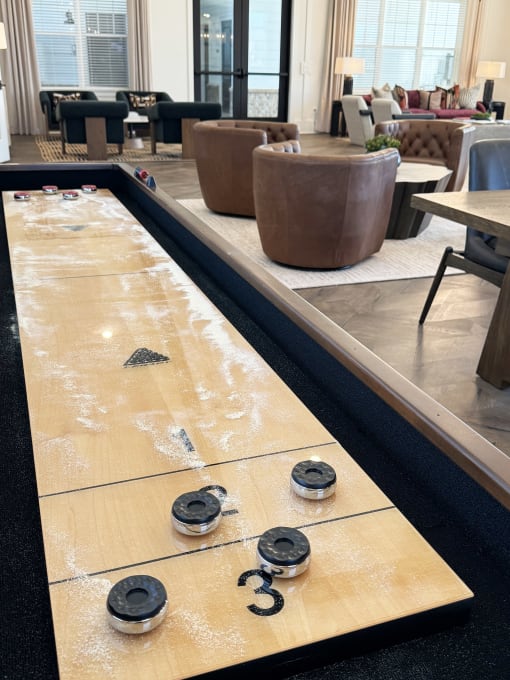 a shuffleboard table in the lobby of a hotel